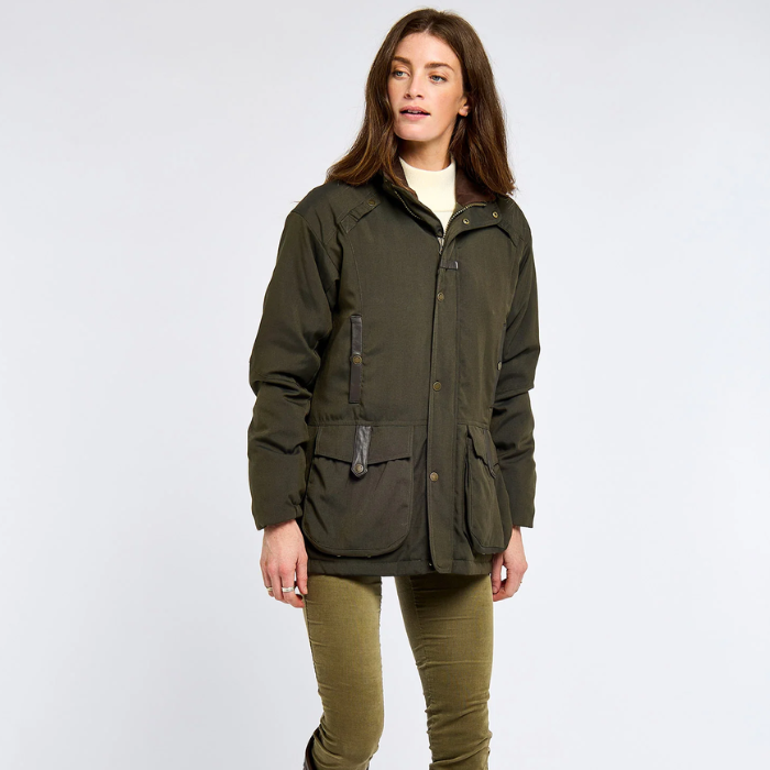 woman wears a cream top with a green jacket and olive trousers on a white background