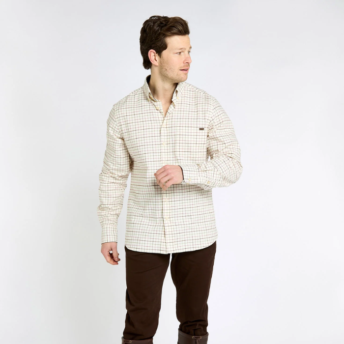 Man wearing a checkered shirt and brown pants on a white background