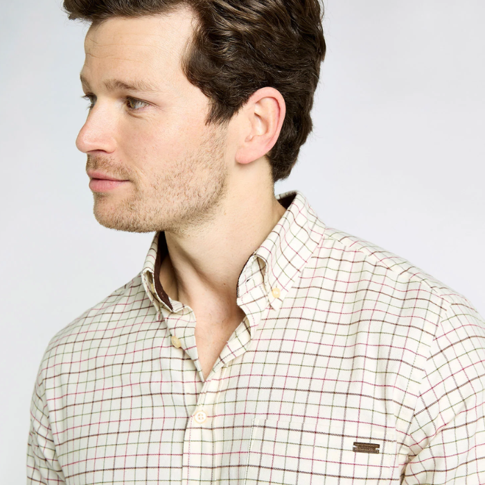 Man wearing a checkered shirt against a plain background