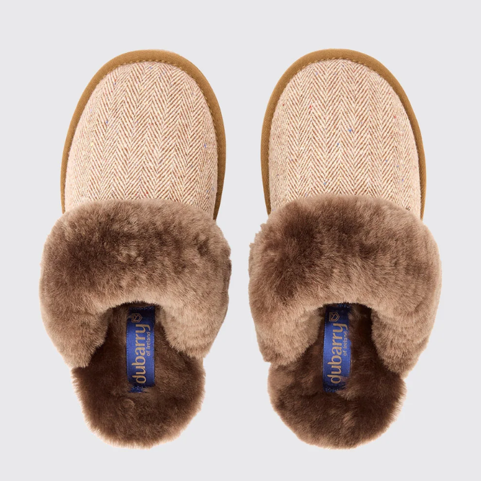 Pair of brown slippers with fur trim on a light grey background