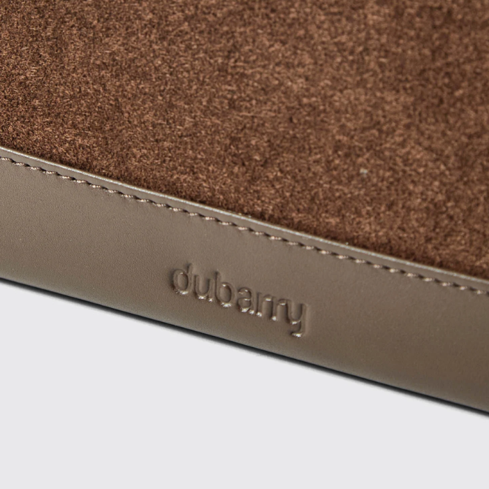 Close-up of a brown and beige product with 'dubarry' branding on a light grey background