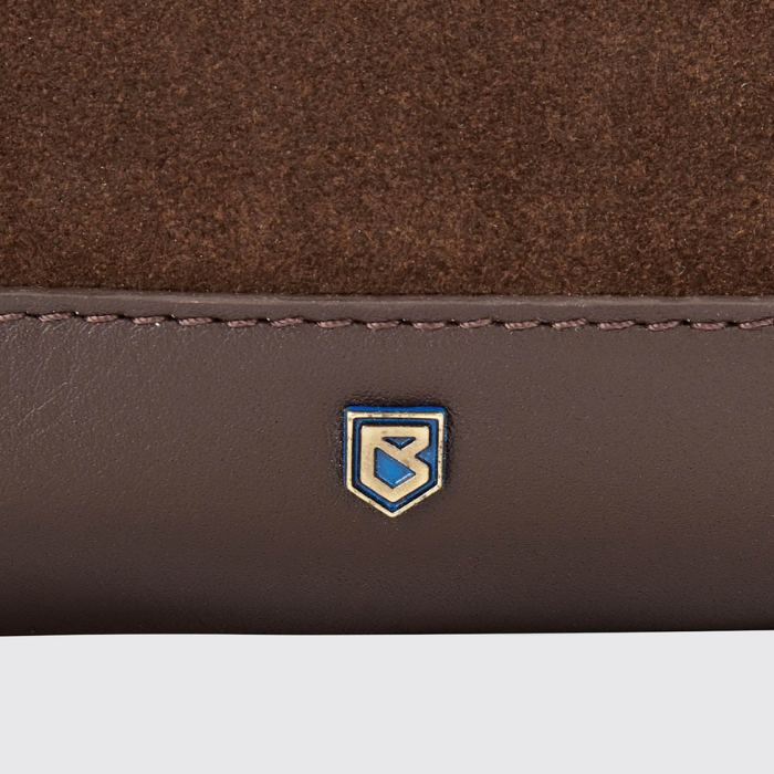 Close-up of a brown leather product with a logo on a white background