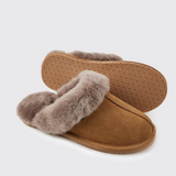 Brown slippers with fur trim on a light grey background