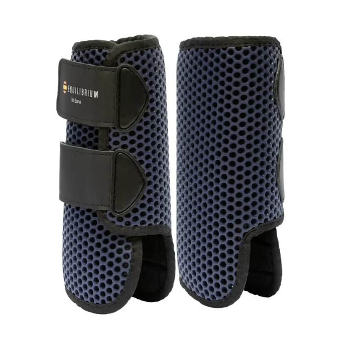 Pair of navy protective horse boots with perforated surface and Equilibrium logo on a white background