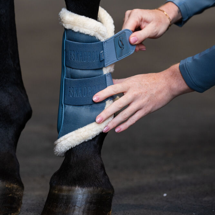 Eskadron Classic Sports Mesh Faux Fur Tendon Boots in Steel Blue being fastened