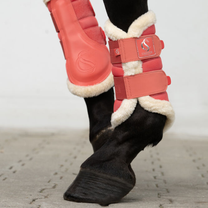 Horse wears the Eskadron Classic Sports Mesh Faux Fur Tendon Boots in Coral Blossom