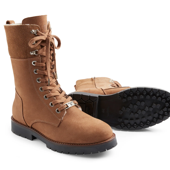 Brown suede boot with black sole on a white background