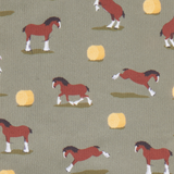 LeMieux AW26 Footsie Socks Clydesdale Variant Colour Clydesdale/Willow.
A close-up of fabric with a repeating pattern of brown horses with white socks and yellow hay bales on an olive green background.