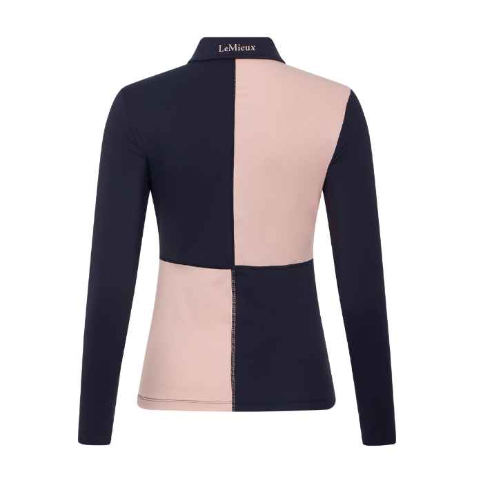 LeMieux AW26 Harlequin Rugby Shirt Base Layer Varient Petal/Navy A women's long-sleeve polo top shown from the back, featuring a color-blocked design with dark navy sleeves and a split back panel in dark navy and light blush pink. The brand name 'LaMieux' is printed on the collar.