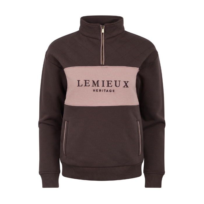 LeMieux AW26 Heritage Quarter Zip Sweat Varient Cocoa. A dark brown quarter-zip sweatshirt with a light pink chest panel featuring the black text 'LEMIEUX HERITAGE'.