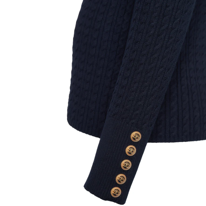 Navy cable knit jumper with gold buttons on a white background