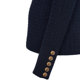 Navy cable knit jumper with gold buttons on a white background