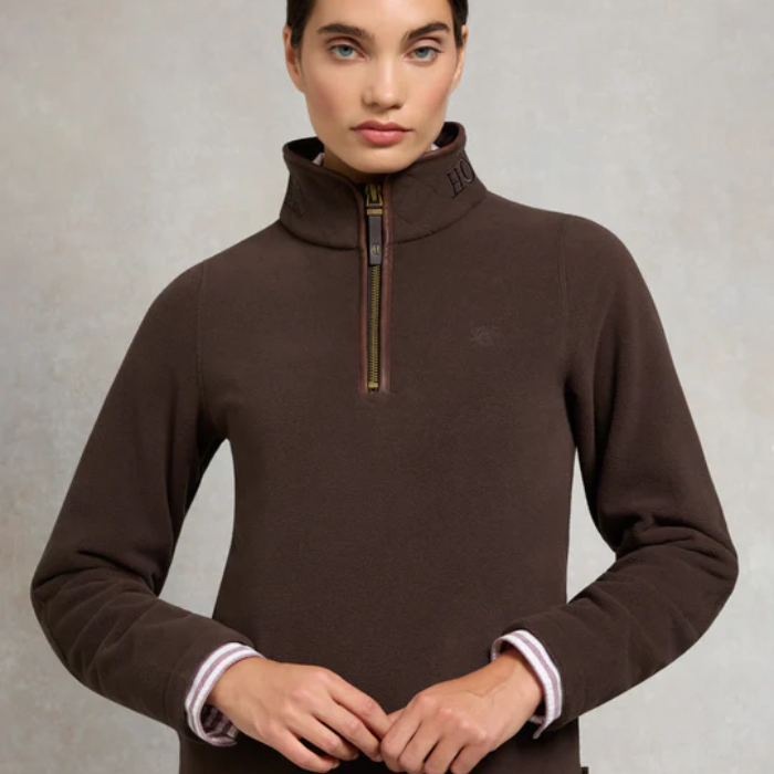 Brown fleece sweater with a quarter zip on a grey background