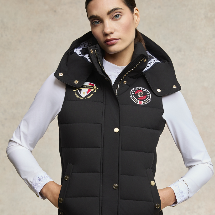 Woman styles the Holland Cooper Team HC Gilet in black with a long sleeved white t-shirt