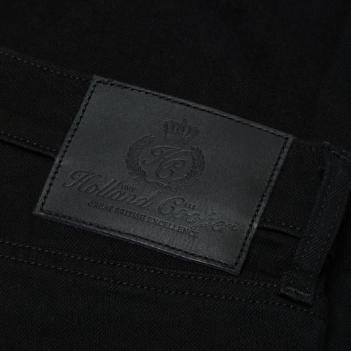 Close-up of a Holland Cooper label on black fabric