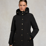 Woman wearing a black coat with a brand logo on a light gray background