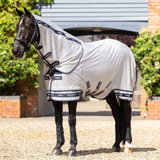 Horse with grey rug on faded background
