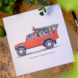 Greetings card with red land rover christmas theme on white background
