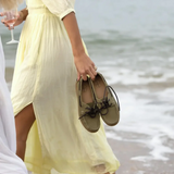 Woman on the beach clutches a pair of the Le Chameau Ladies Galion Femme Shoe in Vert Vierzon