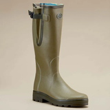 Green rubber boot on a beige background