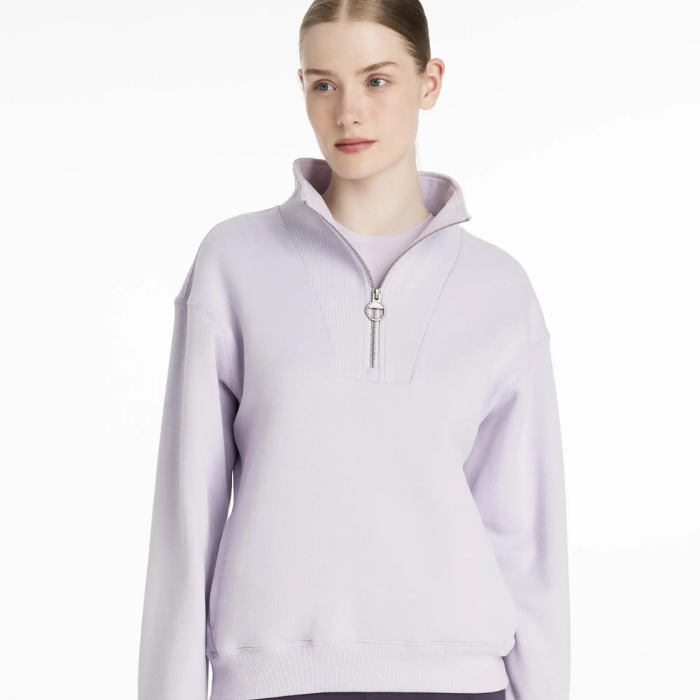 Person wearing a light purple quarter-zip sweatshirt on a white background