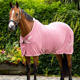 Horse stands wearng the LeMieux Kudos Bamboo Cooler Rug in Peony