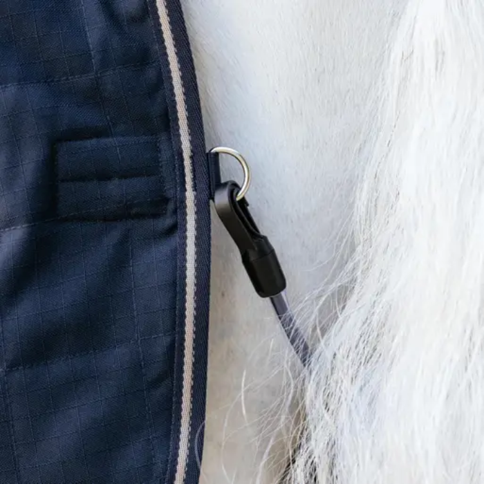 Close-up of a dark blue fabric with a zipper and white fur texture.
