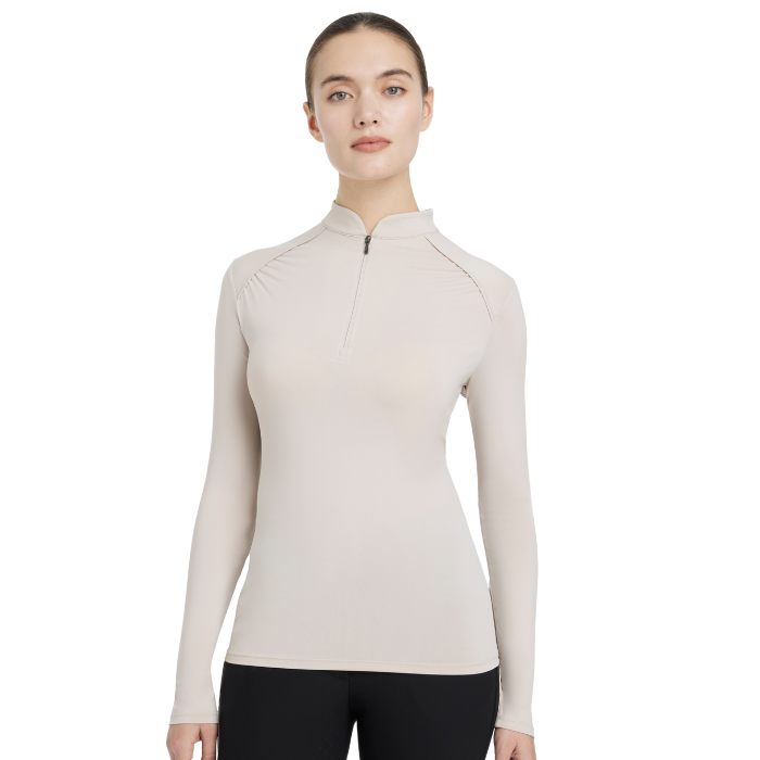 Woman wears the LeMieux Ladies Heyden Lightweight Base Layer in Stone