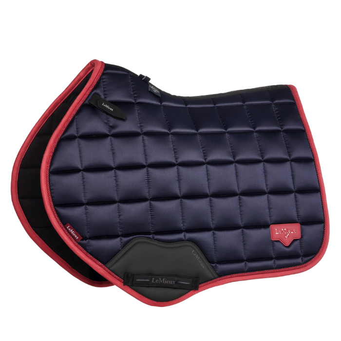 Navy and red quilted saddle pad with visible brand logo on a white background