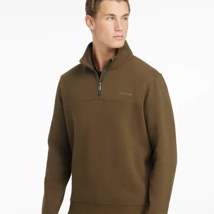 Person wears green quarter zip sweater with LeMieux branding on chest