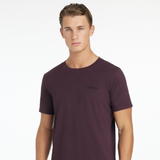 Man wears a purple t-shirt with LeMieux logo on a white background