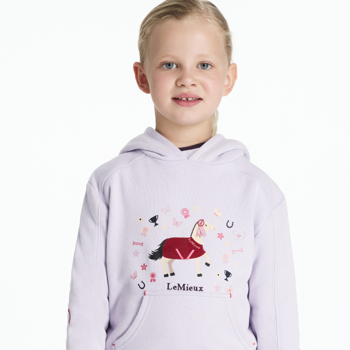 Child wearing a lilac hoodie with horse design and 'LeMieux' branding on a white background