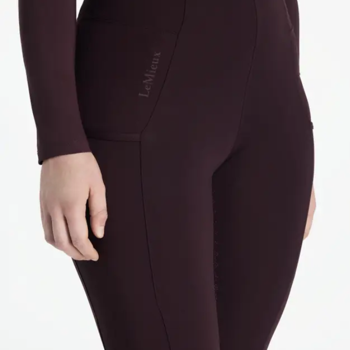 Dark purple riding leggings with a visible LeMieux brand logo on a white background