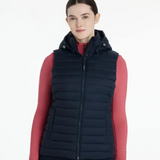 Person wearing a navy puffer gilet over a red base layer on a white background