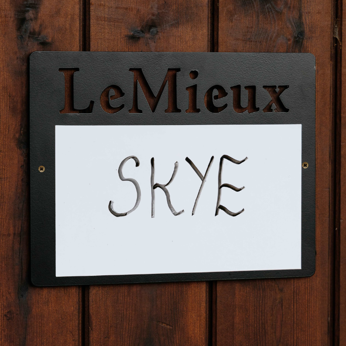 LeMieux stable whiteboard with 'SKYE' on a wooden background