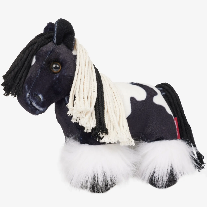 Black and white plush horse toy on a white background