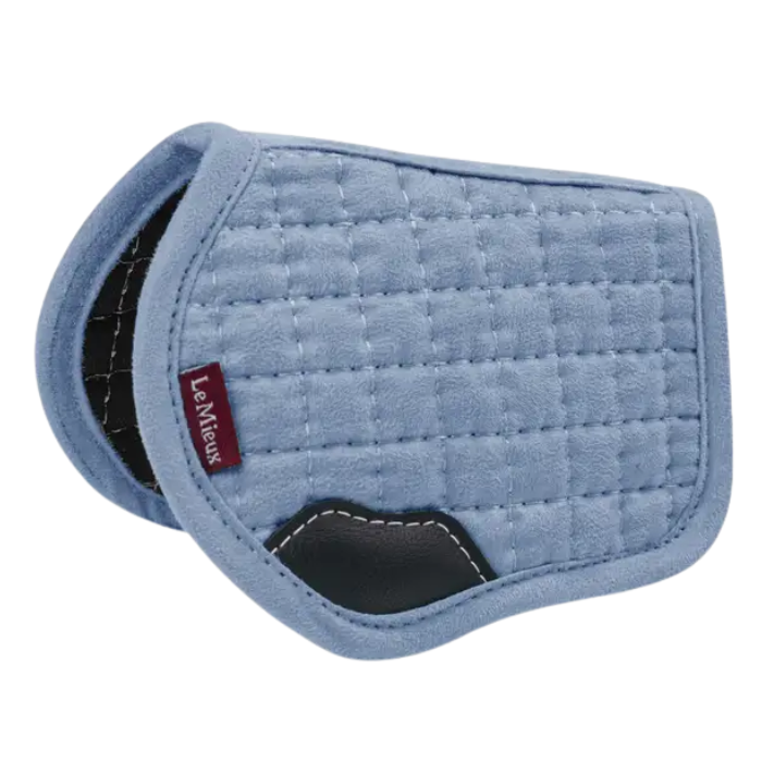 Blue quilted saddle pad with a visible brand logo on a white background