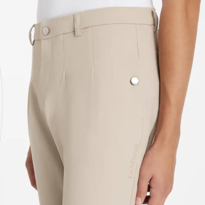 Beige breeches with a button on a white background