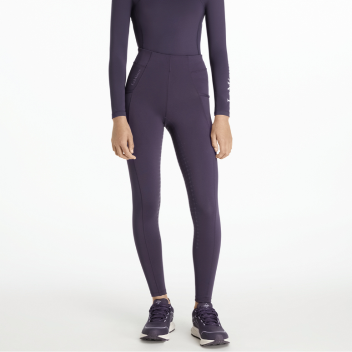 Purple riding tights with long-sleeve top and leggings on a white background