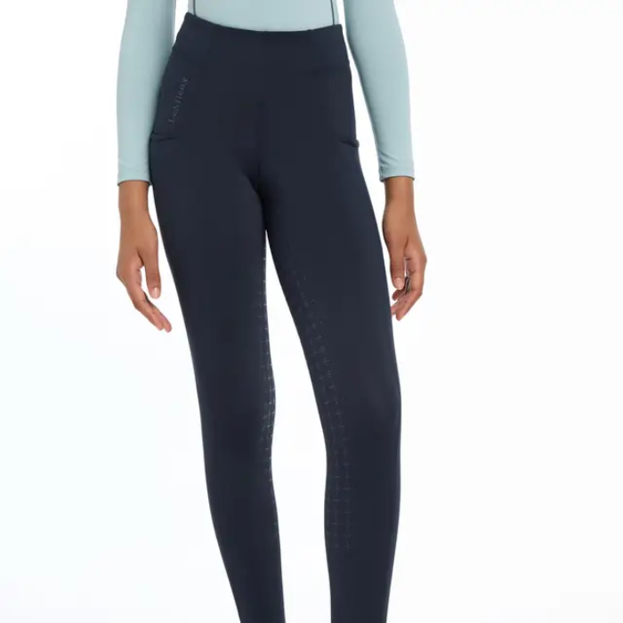 Person wearing navy riding leggings on a white background