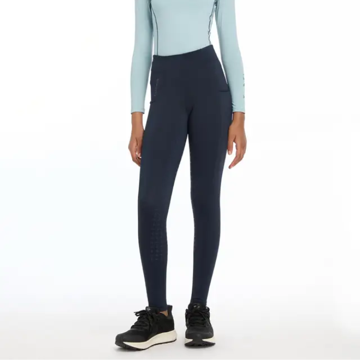 Person wearing navy riding leggings on a white background