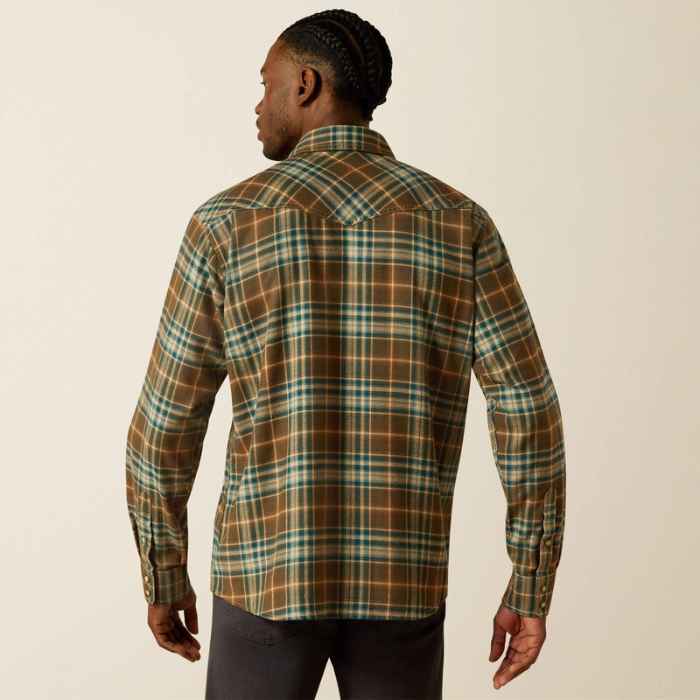 Man wearing a plaid shirt on a beige background