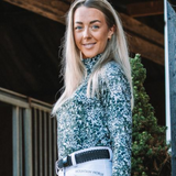 Woman wearing a patterned base layer with 'Mountain Horse' branding outdoors.