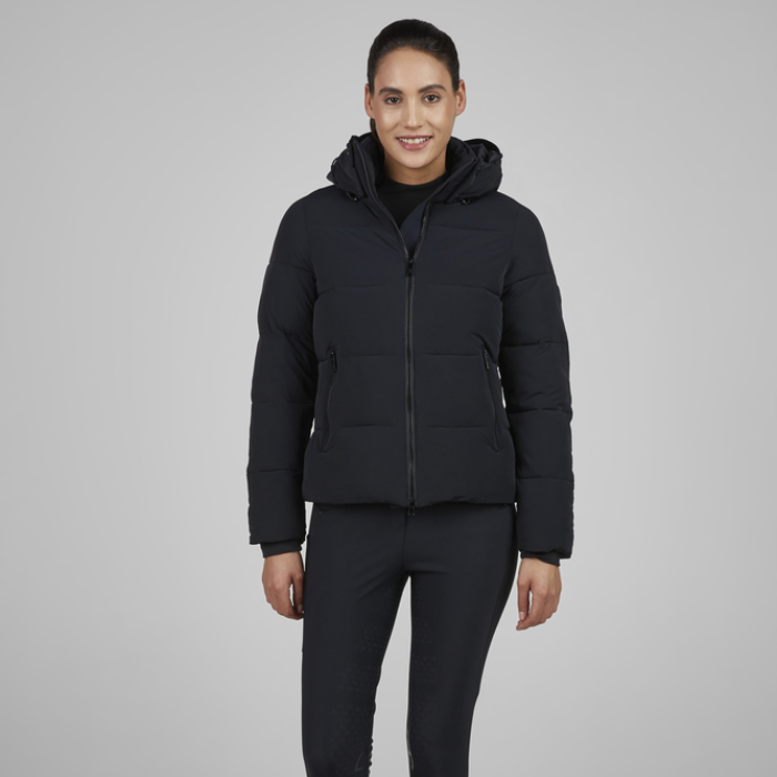 Person wearing a black puffer jacket on a grey background