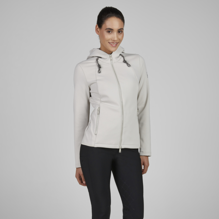 Woman wearing a light grey jacket on a plain background