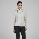 Woman wearing a light grey jacket on a plain background