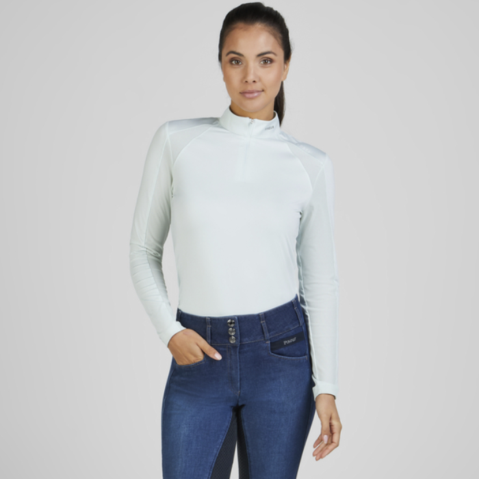 Rider wears the Pikeur Sports Mesh Long Sleeve Baselayer in Ice Blue with jeggings