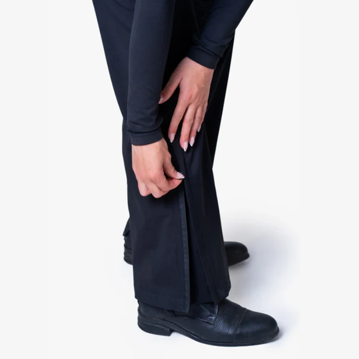 Person wearing black trousers and shoes on a white background