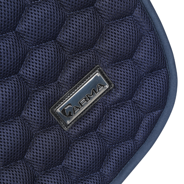 Close-up of a navy blue quilted saddle pad with a brand logo on a white background