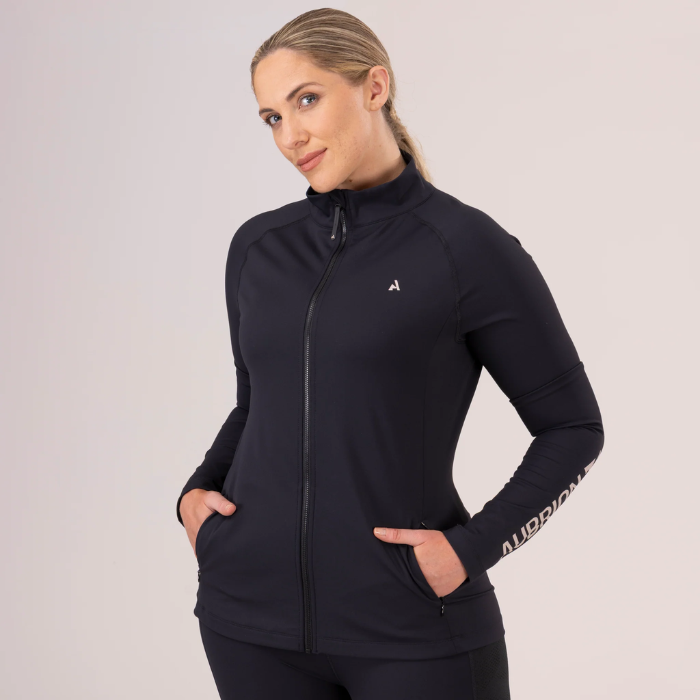 Woman wears the Shires Aubrion React Non-Stop Mid-layer in Shadow